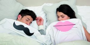 Couple in bed with lips and moustache